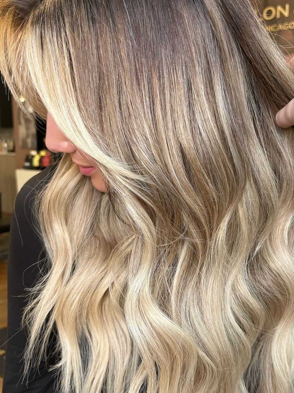 A close-up of beautifully highlighted wavy blonde hair.